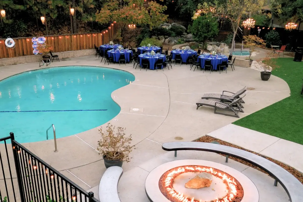 Drone shot of Chandelier Grove with fire pit area, tables set up around the pool