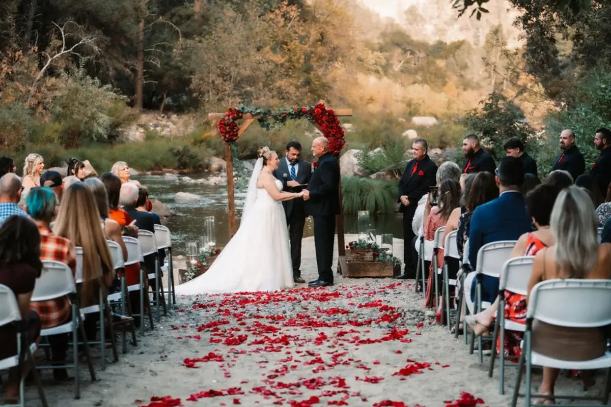 Wedding at Yosemite cedar lodge hidden beach with bride and groom at alter in front of Merced river