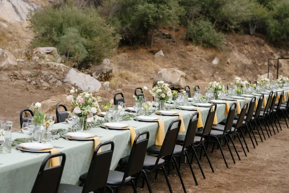 Wedding set up at event venue called granite peak, it is a long table with chairs, flowers and table setting